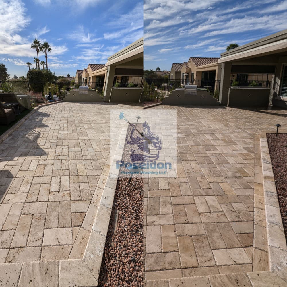 Paved outdoor area with a stone finish, showcasing landscaping and palm trees.