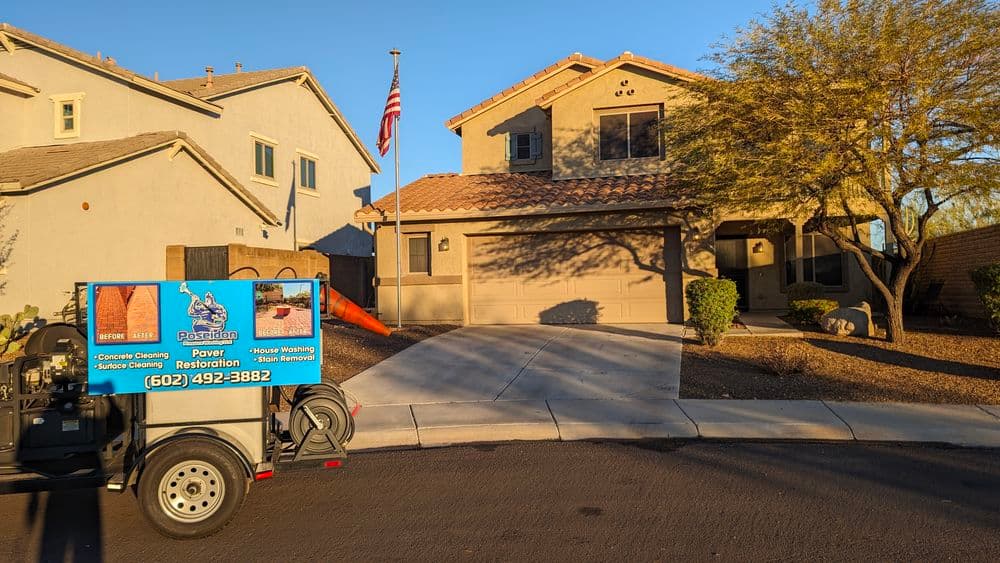 Power washing service truck in front of a residential home with an American flag.