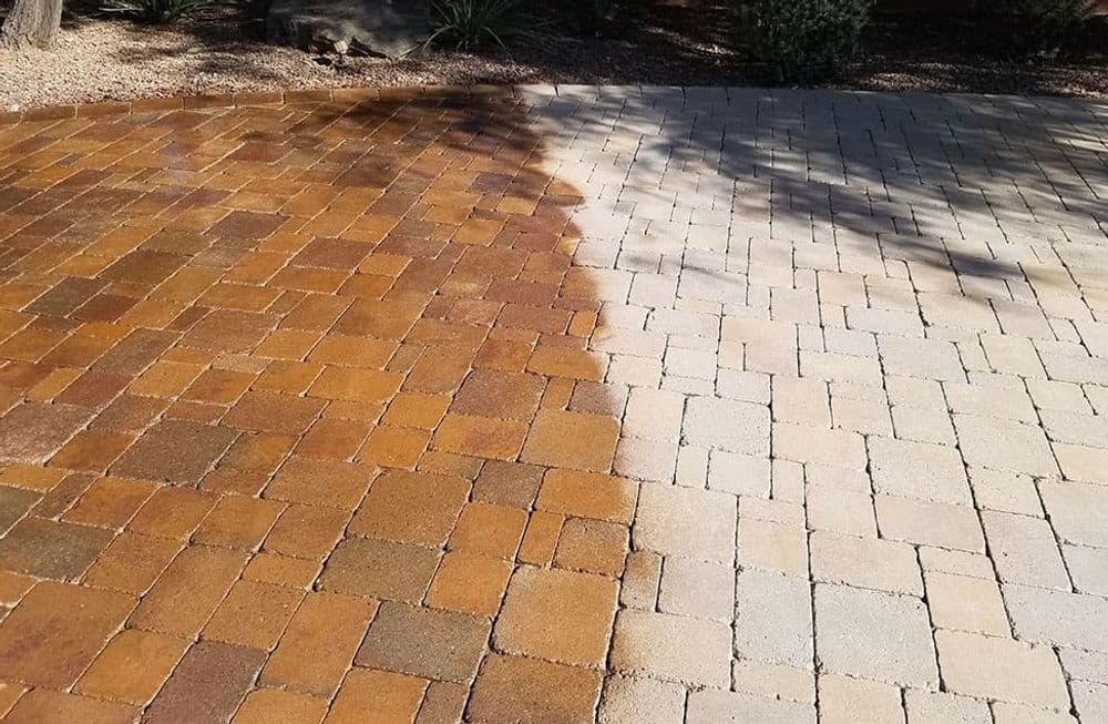 Before and after comparison of cleaned paver stones, showcasing color and texture difference.